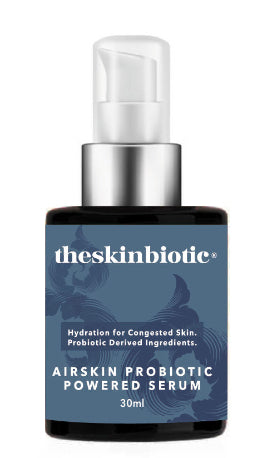 Probiotic Skincare Bottle with label that says theSkinBiotic Airskin Probiotic Powered Serum with a grey blue bottle and white writing . The bottle is amber glass and has a white serum top.